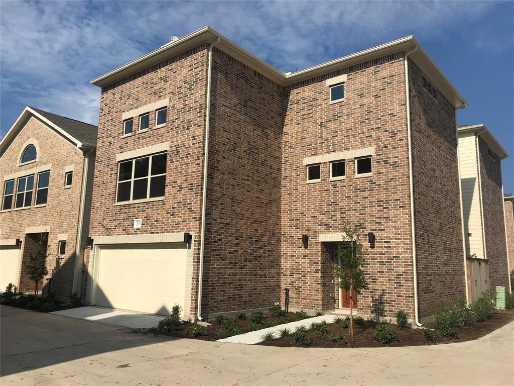 Brickwork, windows, and landscaping at a Houston residence
